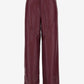 Maroon leather pants on a white background