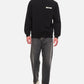 Black sweatshirt with a small white logo on a white background
