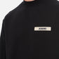Black sweatshirt with a small white logo on a white background