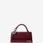 Red handbag with a visible brand logo on a light gray background