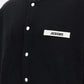 Black varsity jacket with a logo on the chest against a white background