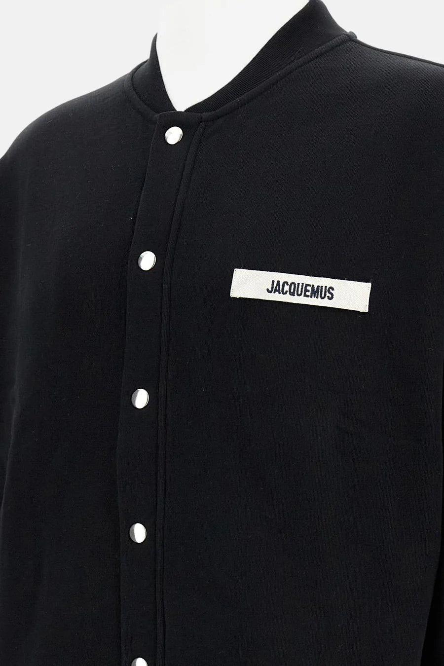 Black varsity jacket with a logo on the chest against a white background