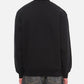 Black sweatshirt with a small white logo on a white background