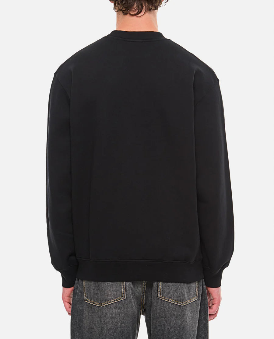 Black sweatshirt with a small white logo on a white background