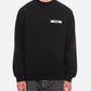 Black sweatshirt with a small white logo on a white background
