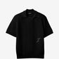 Black polo shirt with a monogram on a white background