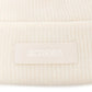 Beige knit sweater with 'Jacquemus' branding on a light background