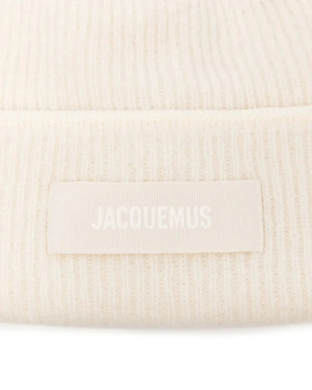 Beige knit sweater with 'Jacquemus' branding on a light background
