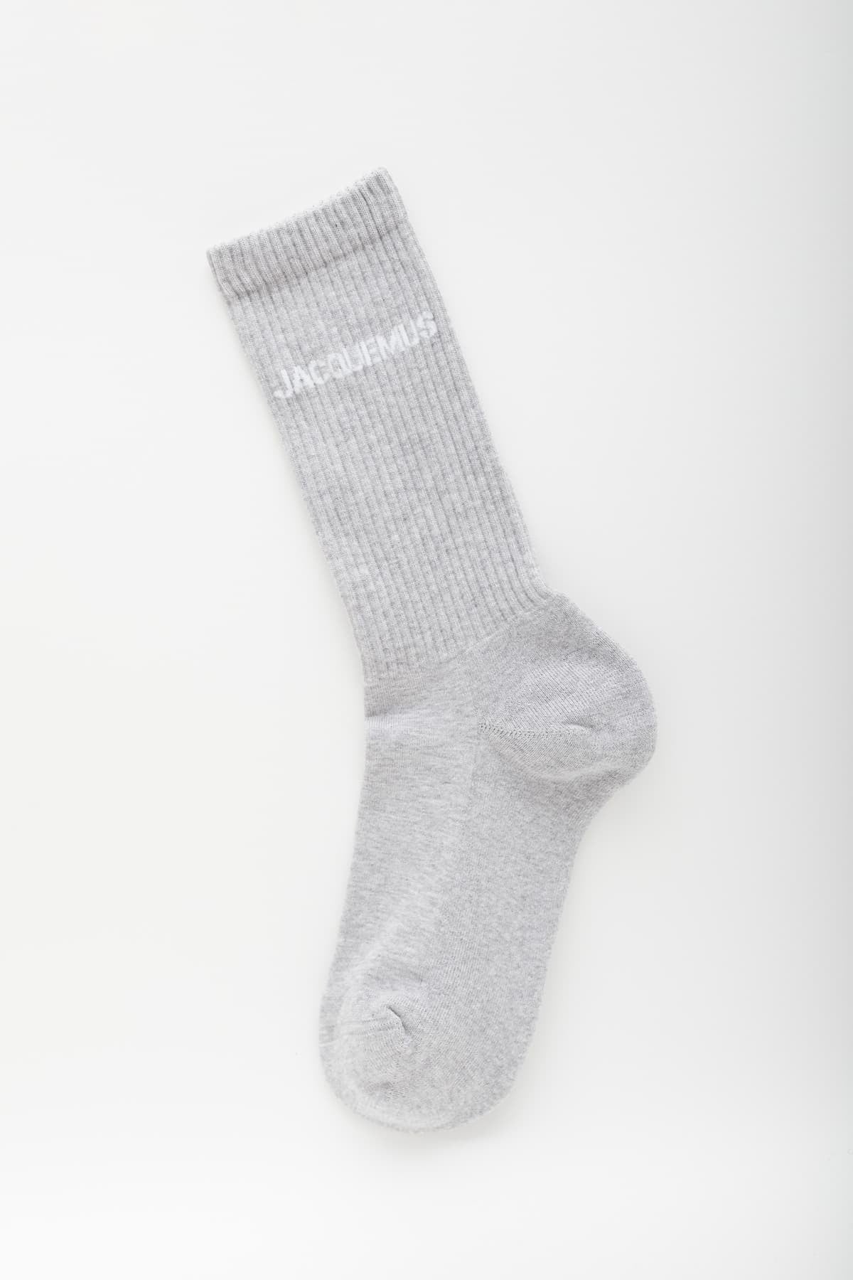 Grey sock with 'Jacquemus' branding on a white background