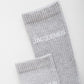 Grey sock with 'Jacquemus' branding on a white background