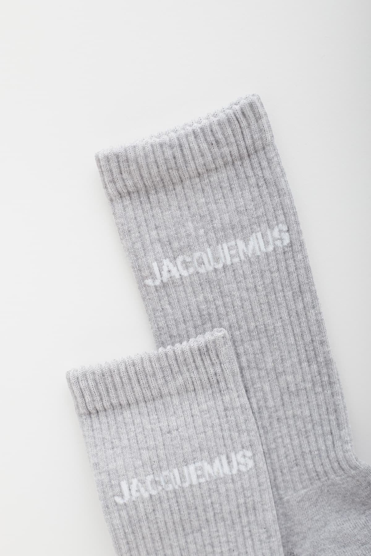 Grey sock with 'Jacquemus' branding on a white background