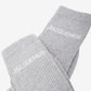 Grey sock with 'Jacquemus' branding on a white background