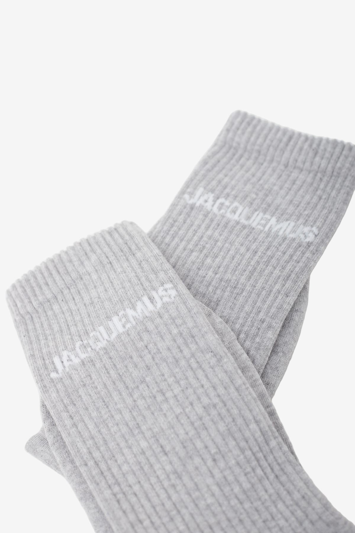 Grey sock with 'Jacquemus' branding on a white background