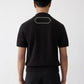 Black polo shirt with a monogram on a white background