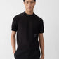 Black polo shirt with a monogram on a white background
