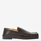Brown loafer shoe on a light gray background