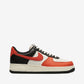 Sneaker with black, red, and white color scheme on a light gray background