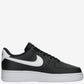 Black sneaker with a white logo on a light gray background