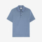 Blue polo shirt on a light gray background