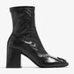 Black ankle boot with block heel on a white background