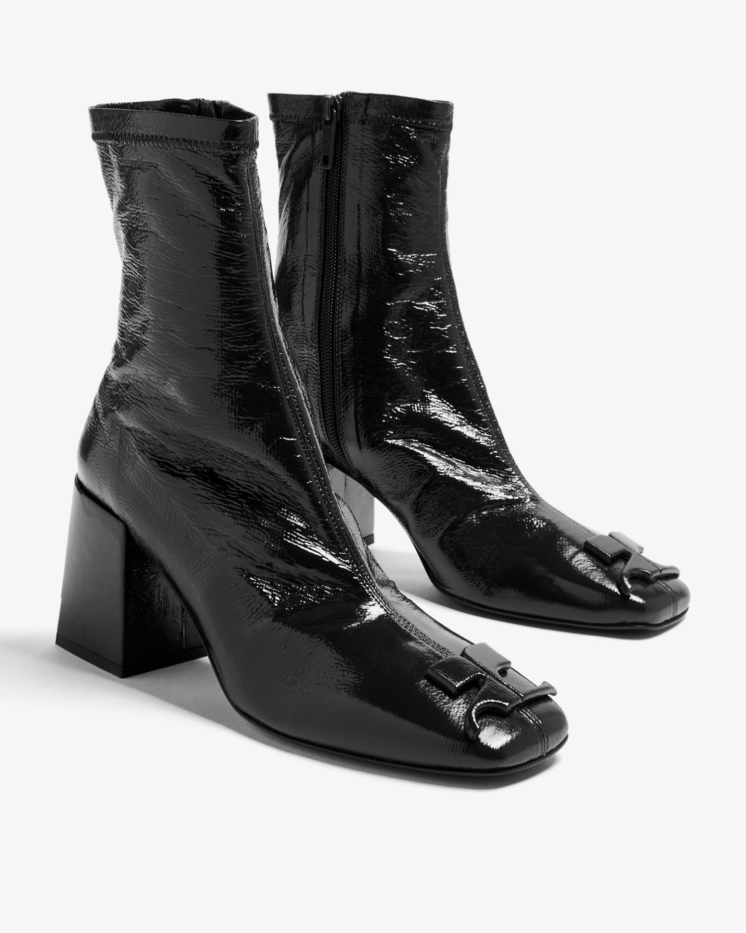 Black patent leather tabi boots on a white background