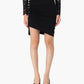Black lace top and skirt worn by a person on a white background