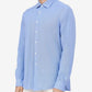 Man wearing a light blue button-up shirt against a white background