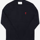 Black long-sleeve shirt with a red heart design on a white background