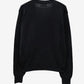 Black cardigan with a small red heart emblem on a white background