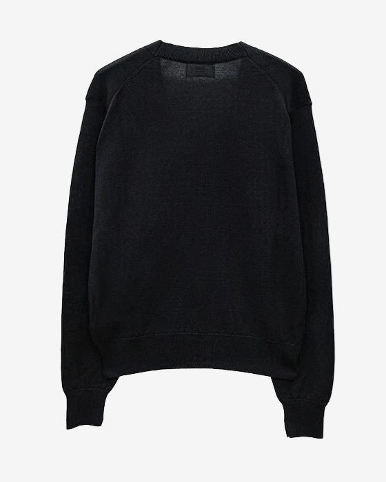 Black cardigan with a small red heart emblem on a white background