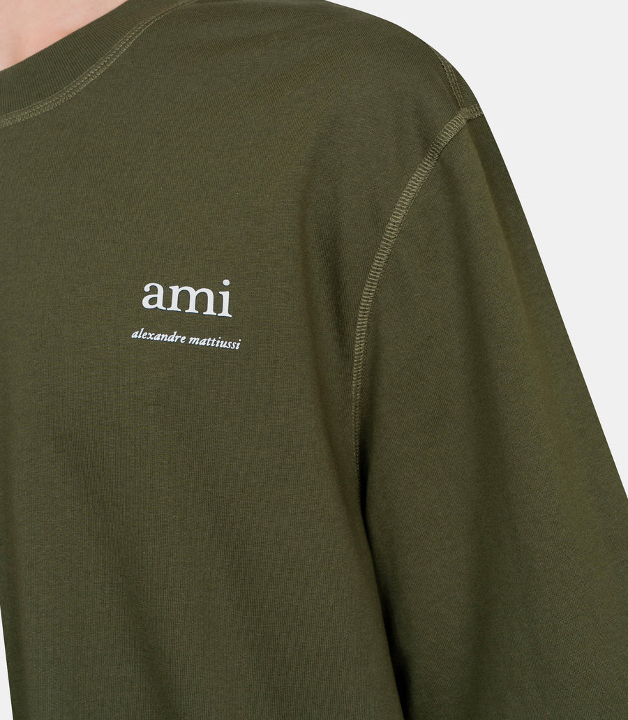 Green t-shirt with a small logo on a white background ami paris