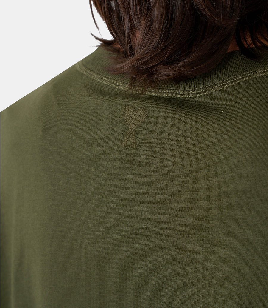 Green t-shirt with a small logo on a white background ami paris