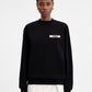 Black sweatshirt with a small white logo on a white background