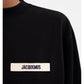 Black sweatshirt with a small white logo on a white background