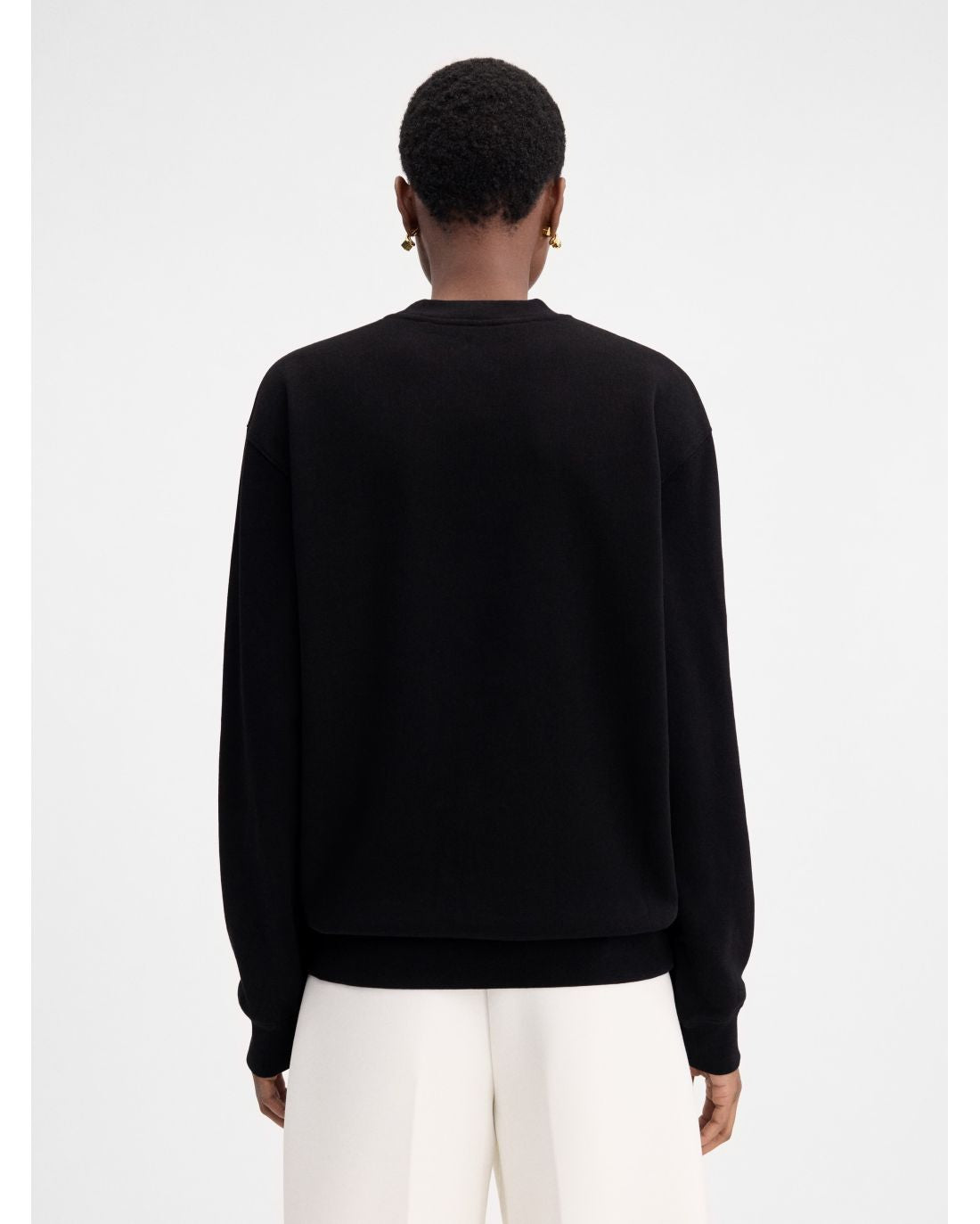 Black sweatshirt with a small white logo on a white background