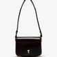 Black handbag with a gold heart emblem on a white background