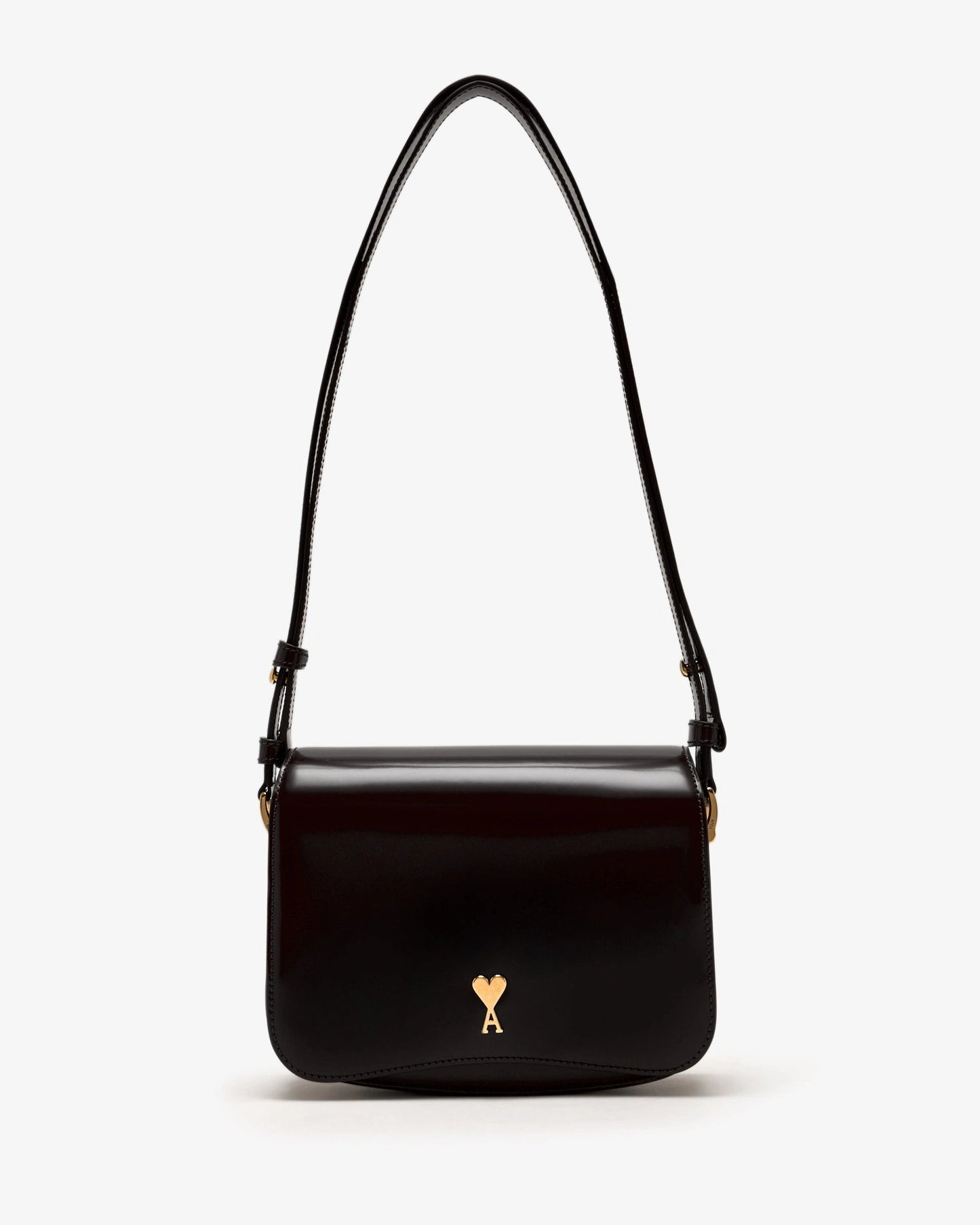 Black handbag with a gold heart emblem on a white background